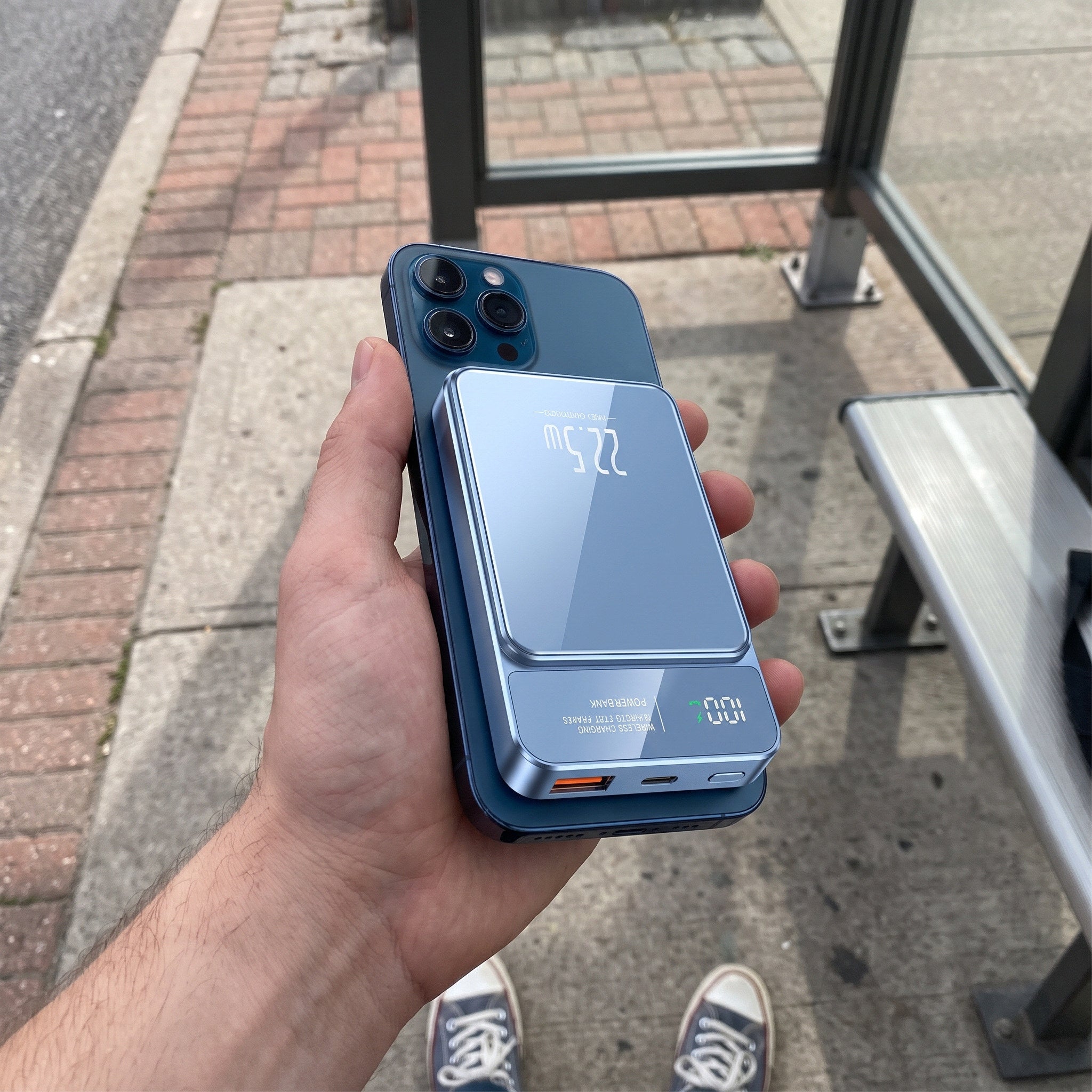 Blue CarryCharge in hand at a bus stop
