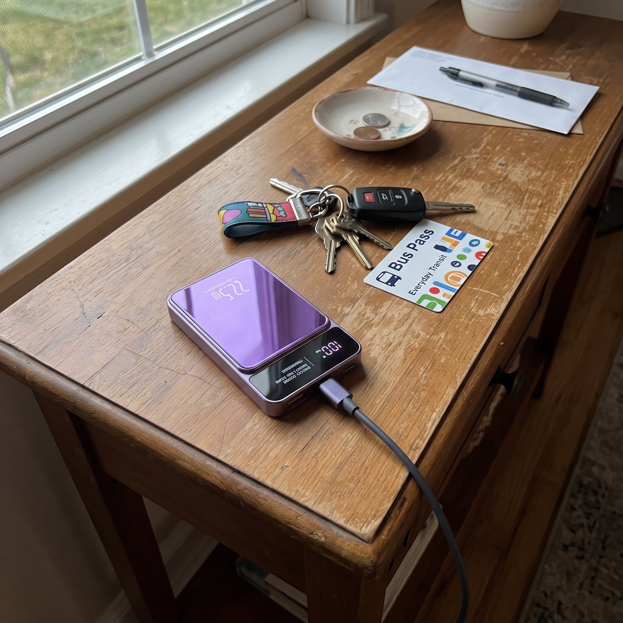 Purple CarryCharge recharging beside keys